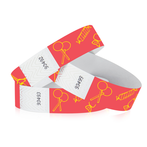 Three red 3/4" Tyvek Wristbands with printed designs of line art candy